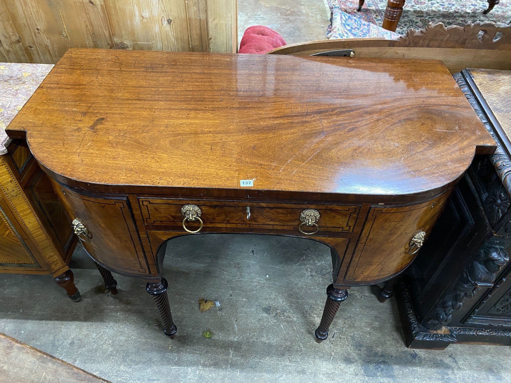 A Regency mahogany bow fronted sideboard, on reeded legs, width 136cm, depth 70cm, height 94cm